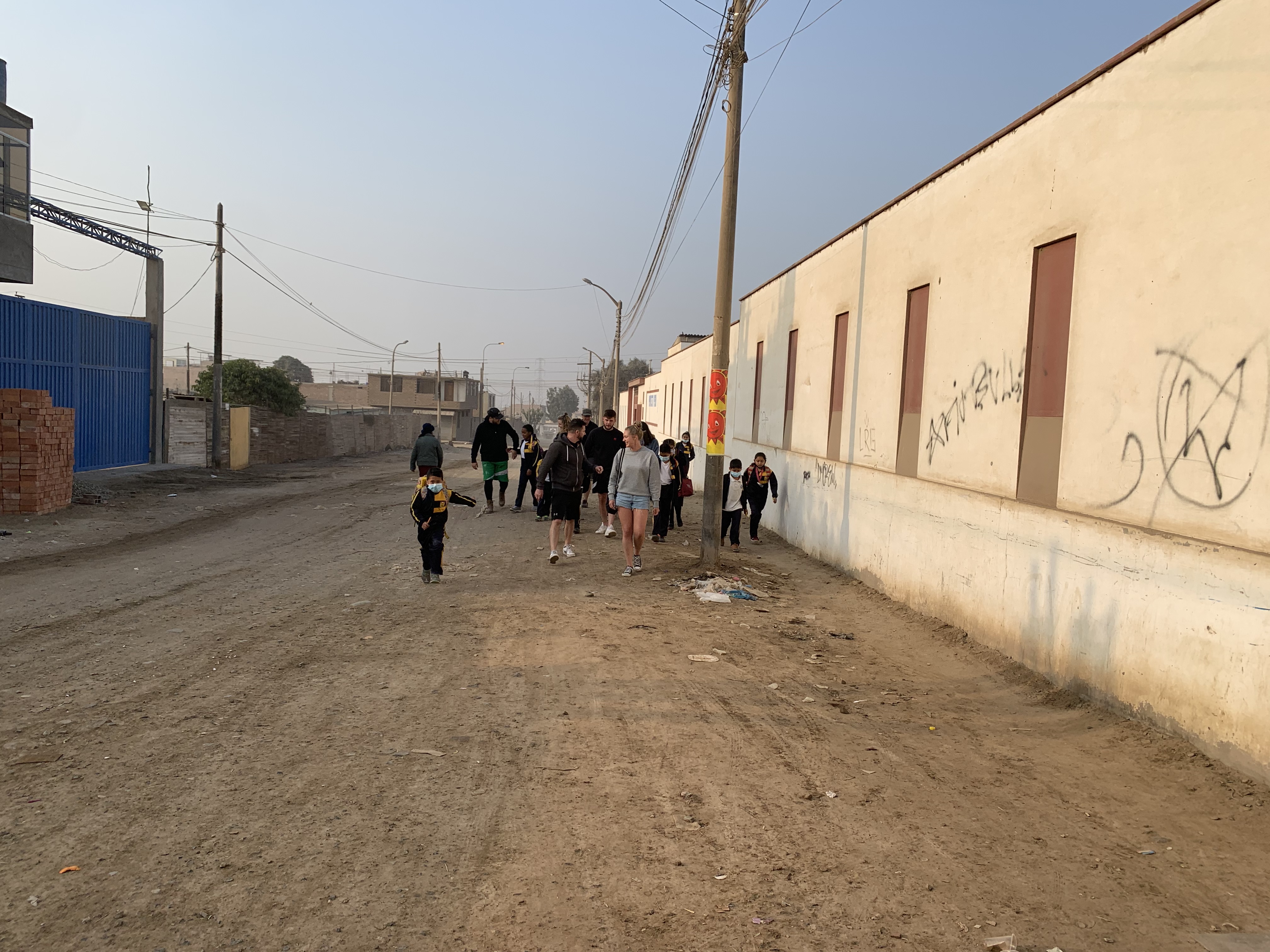 The 2022 volunteer team walks the children to school early in the morning